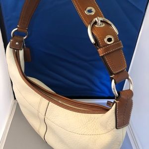 COACH bag with buckle strap.